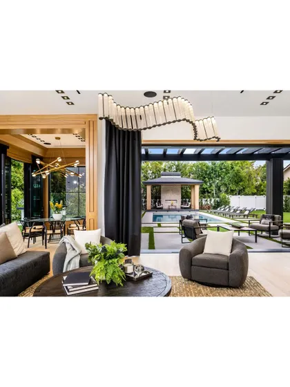 We specialize in creating a seamless flow between indoor and outdoor living. This project features large sliding glass doors that open up the living area to a beautifully landscaped patio and pool, perfect for high-end villa renovations.