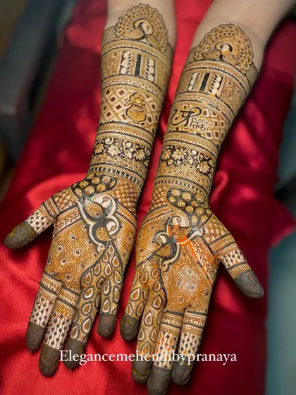 A full view of a custom bridal mehendi with peacock motifs and the groom's name, Pratik, beautifully integrated into the design.