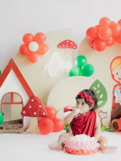 A sweet moment from our Little Red Riding Hood themed cake smash. We provide everything, including the cake, for a fun and messy celebration of the first birthday.