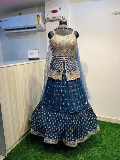 The complete look of the navy blue jacket lehenga set. It’s an elegant and unconventional rental piece that’s perfect for making a statement.