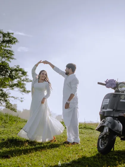 A beautiful silhouette-style shot of them dancing against the bright sky, creating a very artistic and romantic image.