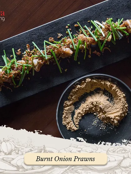 Our Burnt Onion Prawns are a unique and flavourful appetizer. The prawns are cooked with a special burnt onion seasoning and garnished with fresh chives.