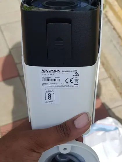 The back of a Hikvision color camera, showing the product label and weatherproof seal.