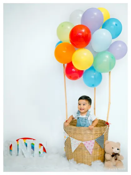 Up, up, and away! This hot air balloon theme is a creative and colorful way to celebrate a first birthday. The vibrant balloons add so much joy.