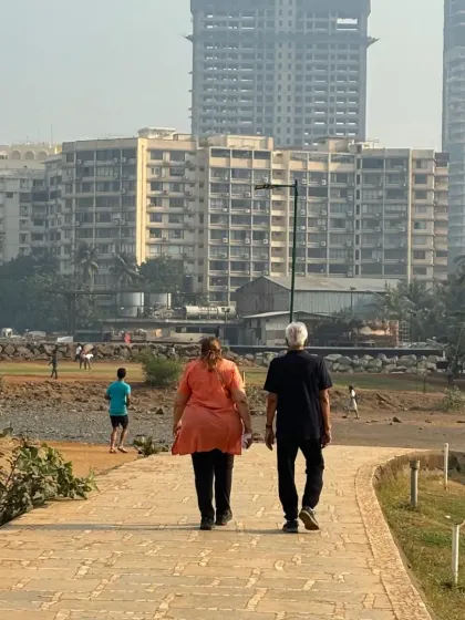 A couple enjoys a walk along the path overlooking the sports ground. World Health Day reminds us that simple activities like walking are the foundation of a healthy life.