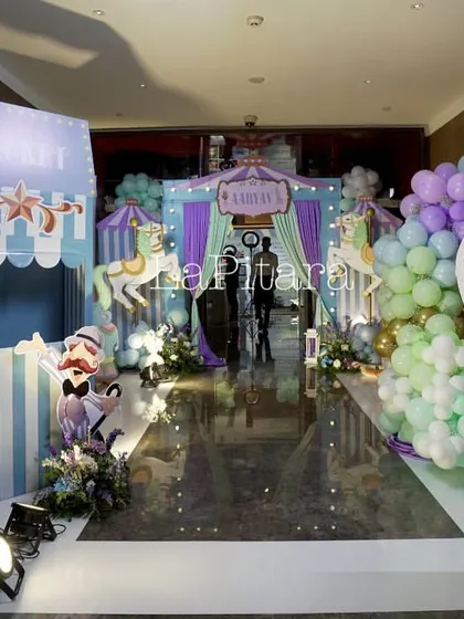 Step right up to this grand carnival entrance. This wide shot showcases the scale of the event, featuring a ticket booth, directional signs, and a hot air balloon photo op, all designed to create the nostalgic and exciting feeling of a classic carnival.