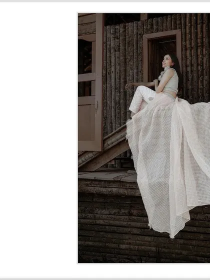A cropped version of the elegant solo portrait, focusing on the bride to be's pose and the flow of her outfit.