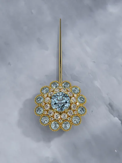 Your presence deserves a piece that rises to meet it. This floral-inspired pin, with its glowing aquamarine center and shimmering layers of diamonds, is crafted to highlight your grace and individuality.