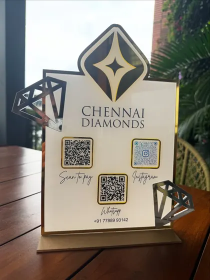 The Chennai Diamonds QR stand displayed on a wooden table, showing how it adds a touch of class to any business environment.