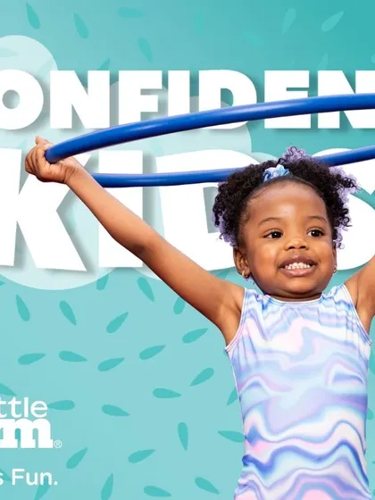 A confident kid is a happy kid. Holding a hula hoop high, this young gymnast is a perfect picture of the joy and self-assurance we aim to build in every class.