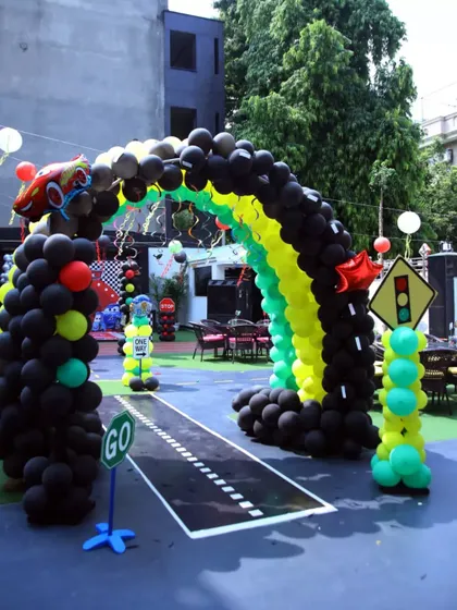The entrance to our Cars themed party, complete with a racetrack floor, a balloon arch, and traffic light decorations. I set the scene for a high-speed adventure from the very first step.