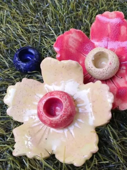 A close-up of hand-sculpted floral incense or candle holders. These pieces showcase how students can create detailed, functional art in our foundation course.