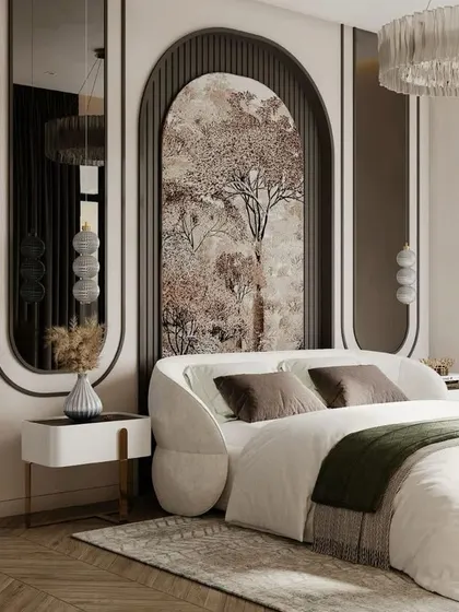 This artistic bedroom design features a unique arched headboard with a nature-inspired mural. The curved forms are echoed in the bed frame and mirrors, creating a soft and elegant aesthetic with a statement chandelier overhead.