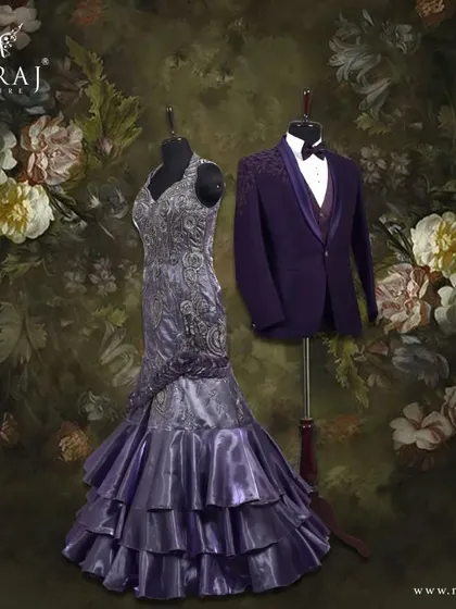 When lavender elegance meets purple sophistication. The groom's dashing purple Italian suit, with its floral patterned vest, is a bold and stylish choice next to the bride's shiny organza mermaid gown.
