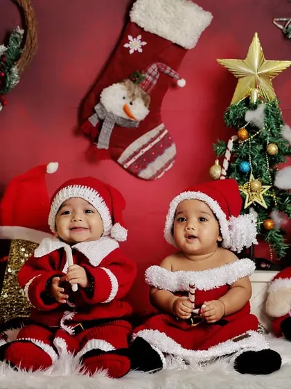 A Christmas-themed photoshoot with twins. Dressed in adorable Santa outfits, they are ready to celebrate their first holiday season together.