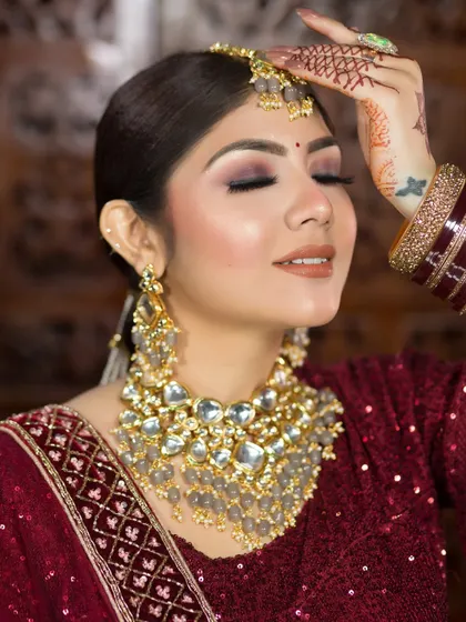 This close-up shows a soft, diffused smokey eye with a nude-brown lipstick, a modern and sophisticated choice for any bride.