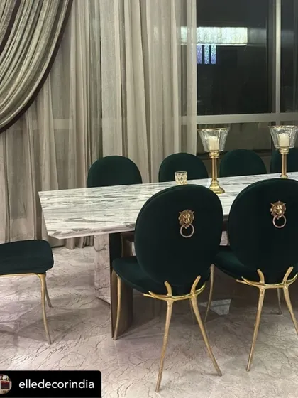Our iconic emerald green velvet dining chairs with lion head knockers, featured in an Elle Decor editorial. These chairs are a perfect example of our commitment to bold, unforgettable design.