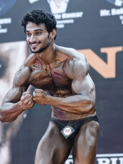 The most muscular pose on stage, with a smile. Even when your body is pushed to the limit, the joy of competing makes it all worthwhile.