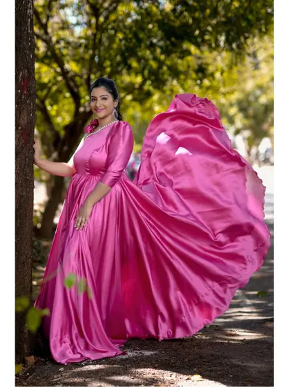 The flowing fabric of this pink satin one-shoulder gown creates a beautiful, dynamic effect, perfect for capturing movement and joy in your photos.