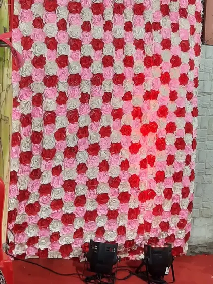 Another view of the artificial rose flower wall, showing how it looks with uplighting. I can provide lights to enhance the backdrop.