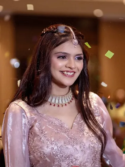 A joyful moment as the bride is showered with confetti. Her bright smile shows the happiness of being surrounded by loved ones.