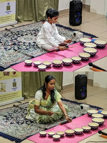 Two parent-child pairs learning the Jaltarang during our special camp. It is a joy to see families completely absorbed in the music, learning a new skill together.
