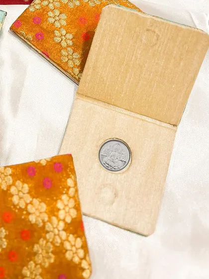 A custom coin holder in a beautiful brocade fabric, a traditional way to gift a silver or gold coin.