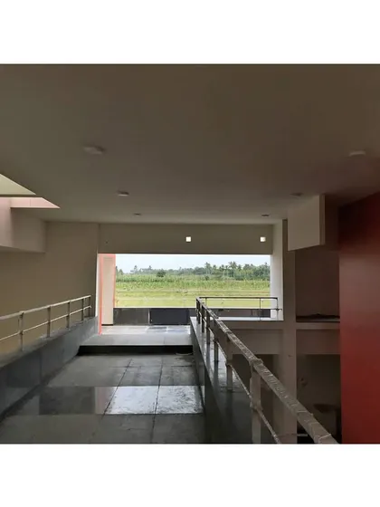 A ramp provides access to the upper level of the temple, offering views of the surrounding green fields.