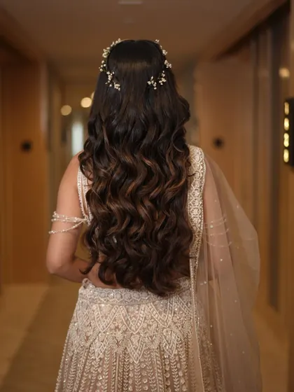 The hallway shot captures the glamour of this Sangeet hairstyle perfectly. The waves and subtle accessory create a look of effortless elegance.