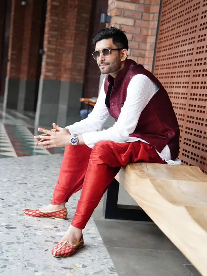A moment of quiet contemplation before the event begins, dressed in vibrant traditional wear.