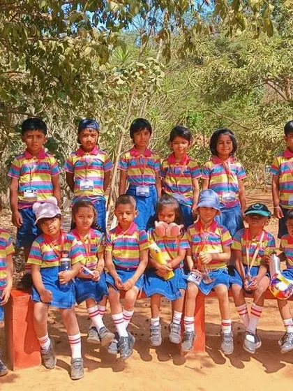 A class photo from the Jain Farm trip, capturing the happy memories of a day spent in nature.