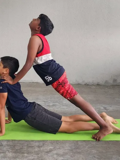 Another example of our partner-assisted cobra pose, highlighting the focus and shared breath between the two campers.
