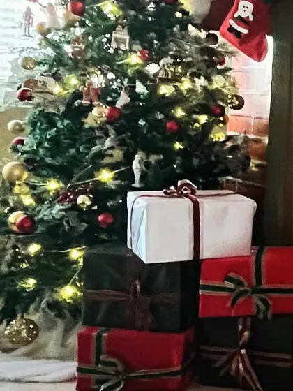 A beautifully decorated Christmas tree with presents underneath, creating a cozy and festive atmosphere.