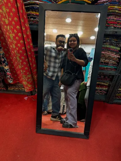 A mirror selfie during a fabric sourcing trip with a client. We often go shopping together to find the perfect materials for custom outfits.
