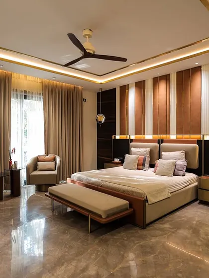 This master bedroom features a striking accent wall with vertical panels of wood and leather. The warm, integrated lighting and luxurious marble-like flooring create a sophisticated and modern retreat.