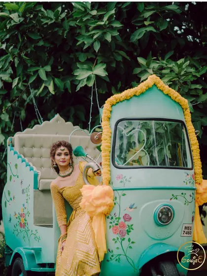 A quirky and fun photo prop for a Mehendi or Haldi, featuring a beautifully painted auto-rickshaw.