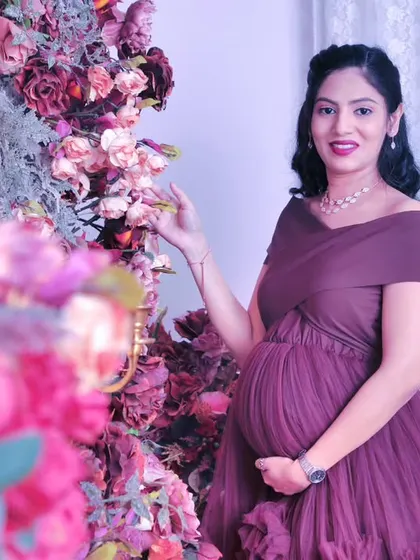 A lovely portrait of the mom-to-be interacting with the floral decor, adding a touch of softness and life to the photograph.