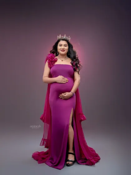 This full-length portrait showcases the elegant silhouette of the magenta gown against a softly lit backdrop. My focus is on creating a balanced and artistic composition.