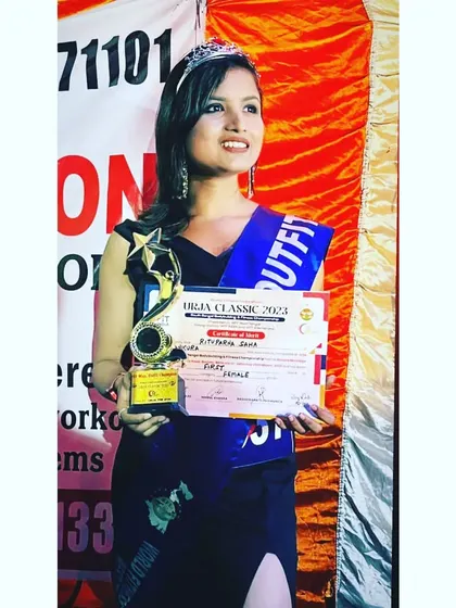 Holding my trophy and certificate after winning the "Miss. Outfit" award. Success comes from working hard in silence and letting the results speak for themselves.