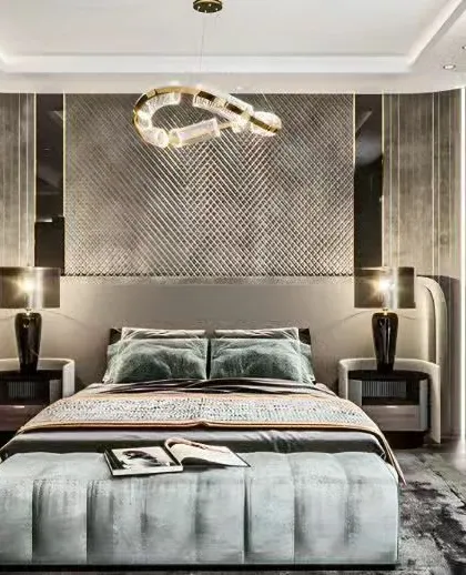 A sophisticated bedroom featuring a textured, quilted accent wall and unique modern lighting. The cool color palette of grays and blues creates a serene and restful environment.