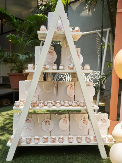 A stylish A-frame shelf displaying party favors for a boho-themed birthday. The display is both functional and a beautiful part of the overall event decor.