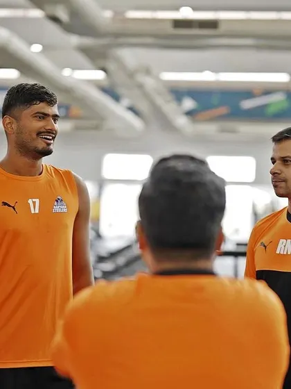 A conversation with one of the players during a gym session. Individual attention and feedback are key to athlete development.