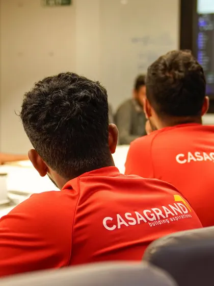Our coaches, seen from behind, are focused on learning about new technologies to improve player training and performance analysis.