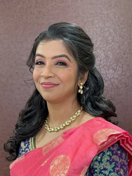 A close-up that shows her happy and confident expression. The makeup is light and fresh, allowing her natural beauty to shine through.