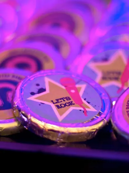 Even the chocolates were on-theme, with custom wrappers featuring a "Let's Rock" microphone design. These small details tie the whole experience together.