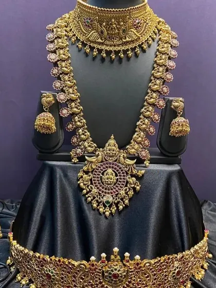 A full bridal set with a unique design, featuring a choker and long necklace with peacock and floral details. The antique finish and kemp stones make it a standout choice for your wedding.