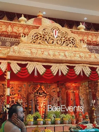 A view of the grand wedding mantap with a priest performing rituals. This image captures the authentic atmosphere of a traditional Hindu wedding ceremony, which we are experts at facilitating.