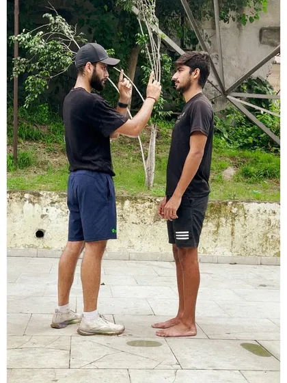 An assessment in progress. I am checking an athlete's posture and alignment, a fundamental step in designing an effective and safe training program.