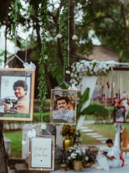 A touching tribute to loved ones who couldn't be present, with their photos hanging from a memory tree.