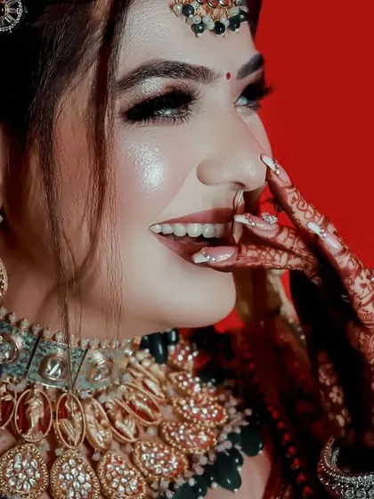 A happy and candid shot of the bride, her smile as bright as her jewellery.